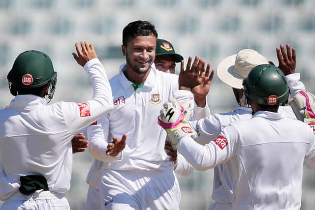Bangladesh's Shakib Al Hasan, second left, celebrates with team-mates after the dismissal of England captain Alastair Cook. Picture: AP Photo/A.M. Ahad