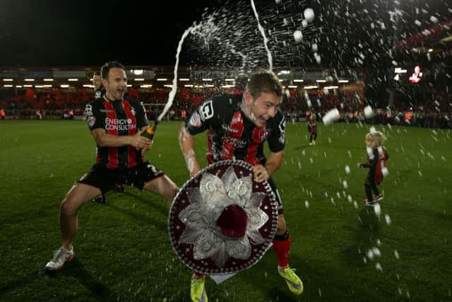 Bournemouth's players celebrate promotion to the Premier League in April last year. Picture: John Walton/PA.
