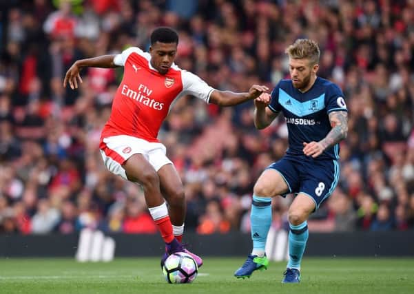 Arsenal's Alex Iwobi (left) and Middlesbrough's Adam Clayton battle for the ball.