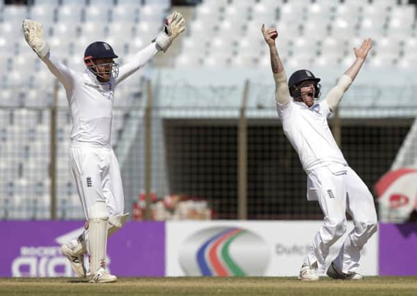 Englands wicketkeeper Jonny Bairstow, left, and Ben Stokes successfully appeal for the dismissal of Bangladeshs Mominul Haque (Picture: AM Ahad/AP).