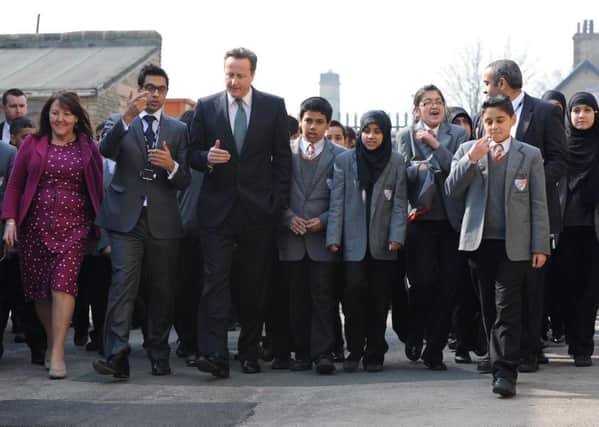 Prime Minister David Cameron meets headteacher Sajid Hussain and children from Kings Science Academy, Bradford.