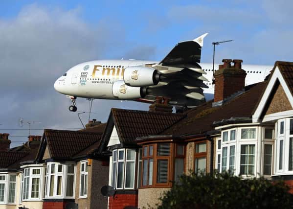 An Airbus A380 plane landing over houses in Myrtle Avenue near Heathrow Airport
