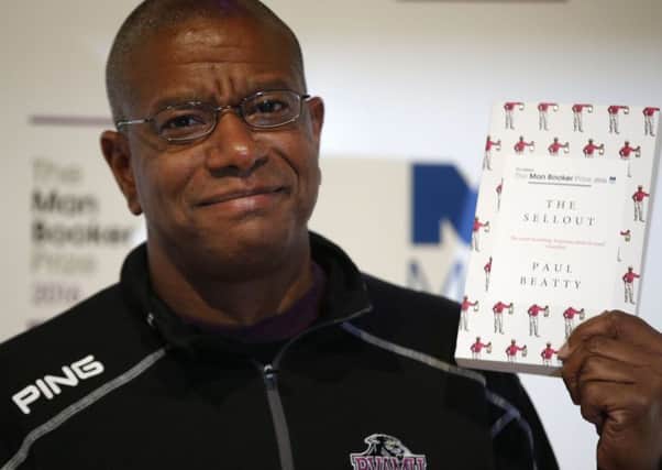 Writer Paul Beatty poses for the media with his book The Sellout