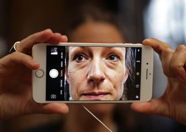 Kathrin Milic tests the camera on an iPhone 7 in the Apple Store in Covent Garden, London. Photo credit: Yui Mok/PA Wire