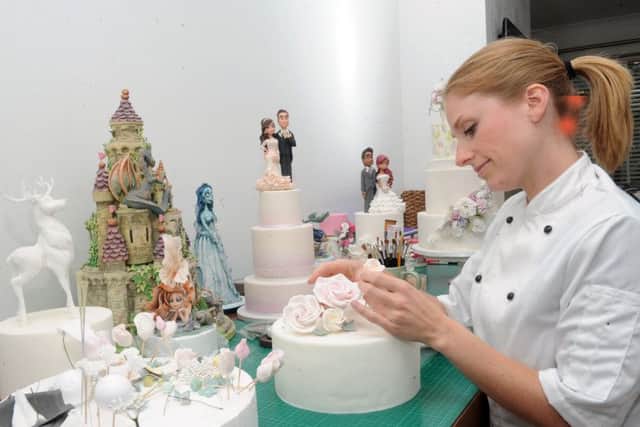 Zoe Hopkinson, of Zoe's Fancy Cakes, works on some cake designs. pic: steve riding