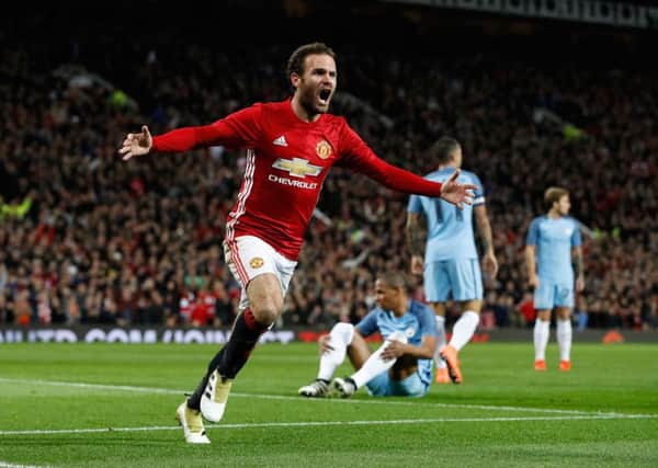 Manchester United's Juan Mata celebrates after scoring his side's winner against Manchester City.