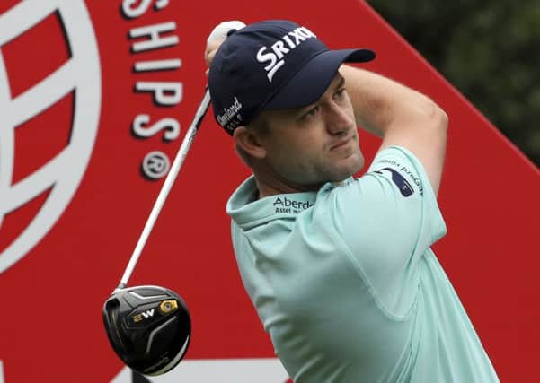 Feeling at home: Russell Knox of Scotland hits a tee shot en route to an opening 66 in Shanghai. (Picture: AP/Ng Han Guan)