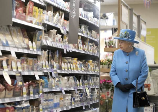 The Queen looks around a Waitrose supermarket during a visit to Poundbury, a new urban development on the edge of Dorchester.
