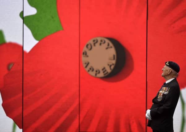 World War II veteran Garth Wright, 97, views a video installation unveiled by the Royal British Legion's Poppy Appeal in Paternoster Square in London, which invites people to rethink Remembrance.