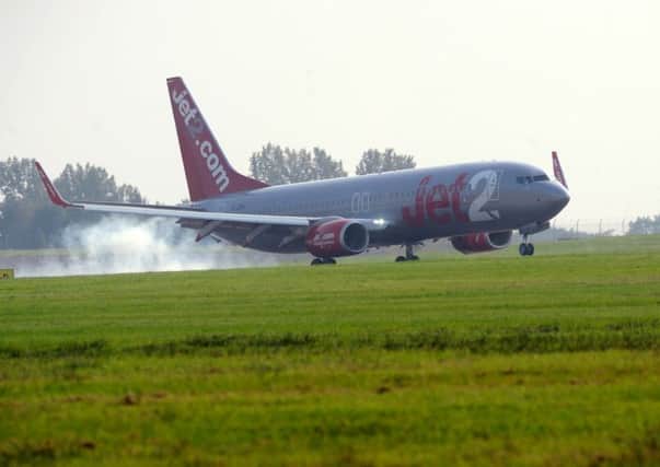 A plane lands at Leeds Bradford Airport.