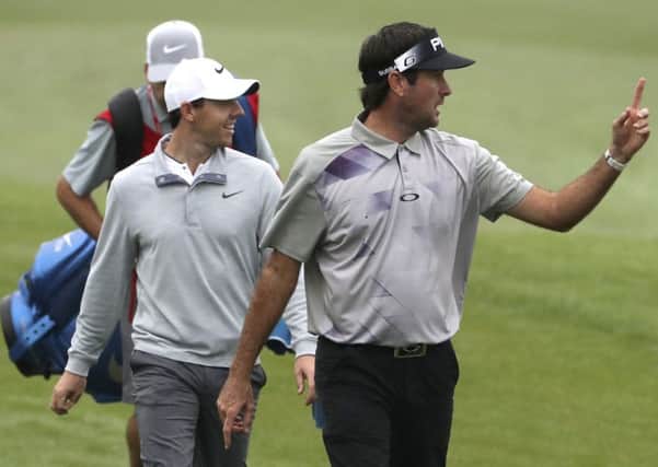 Bubba Watson from the U.S., right, and Rory McIlroy of Northern Ireland walk along the fairway during the WGC-HSBC Champions golf tournament at the Sheshan International Golf Club in Shanghai. (AP Photo/Ng Han Guan)