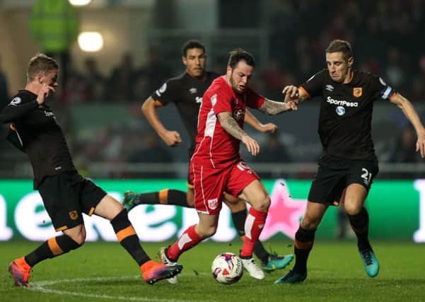 Hull City's Josh Tymon (left) and Michael Dawson (right) battle for the ball with Bristol City's Lee Tomlin (centre)
