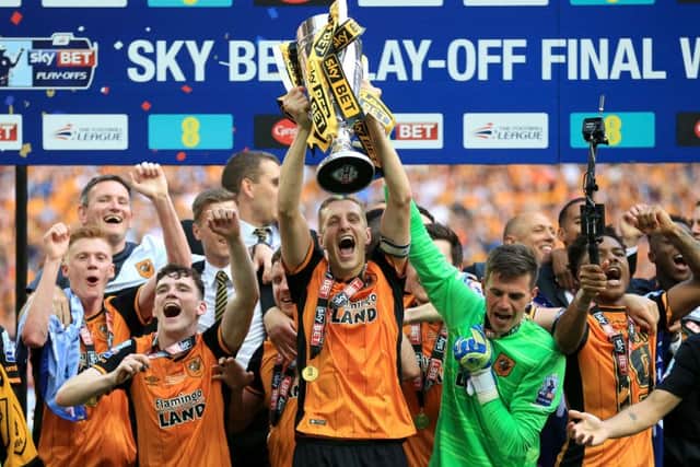 Hull City's Michael Dawson lifts the trophy after winning the Championship Play-Off Final at Wembley Stadium (Picture: PA)