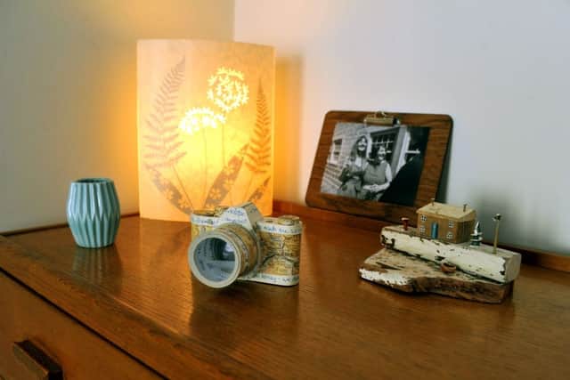 The paper camera is by Jennifer Collier, the lamp by Hannah Nunn and the driftwood cottage by Kirsty Elson