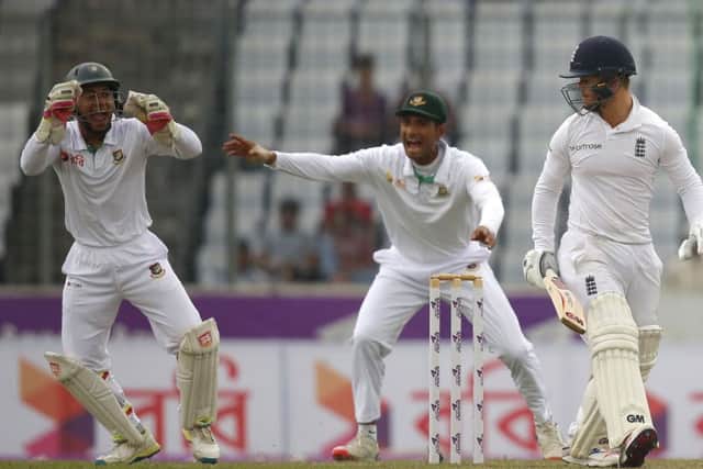 Bangladesh's wicketkeeper Mushfiqur Rahim, left, catches the ball successfully to dismissal of England's Ben Duckett (AP Photo/A.M. Ahad)