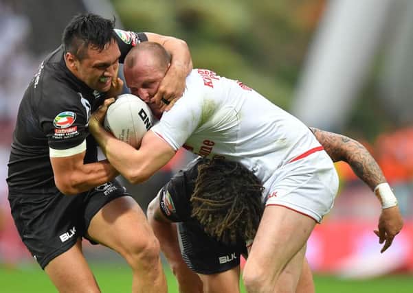England's Dan Sarginson is tackled by New Zealand's Thomas Leuluai during the Ladbrokes Four Nations match at the John Smith's Stadium, Huddersfield. (Photo: PA)