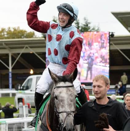 Jockey Jonathan Moore celebrates after riding Irish Cavalier to win the bet365 Charlie Hall Steeple Chase during day two of the bet365 Charlie Hall Meeting at Wetherby Racecourse. (Photo: PA)