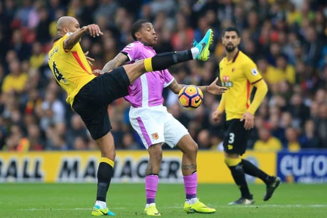 Watford's Younes Kaboul (left) battles for the ball with Hull City's Abel Hernandez (centre) during the Premier League match at Vicarage Road, Watford.  (Photo: PA)