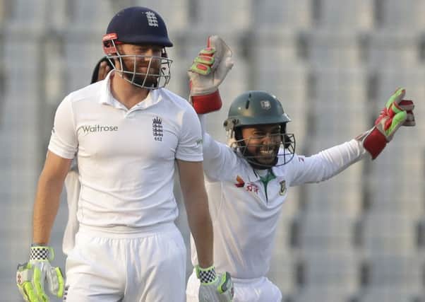 Bangladesh's captain Mushfiqur Rahim, right, celebrates the dismissal of England's Jonny Bairstow, left.