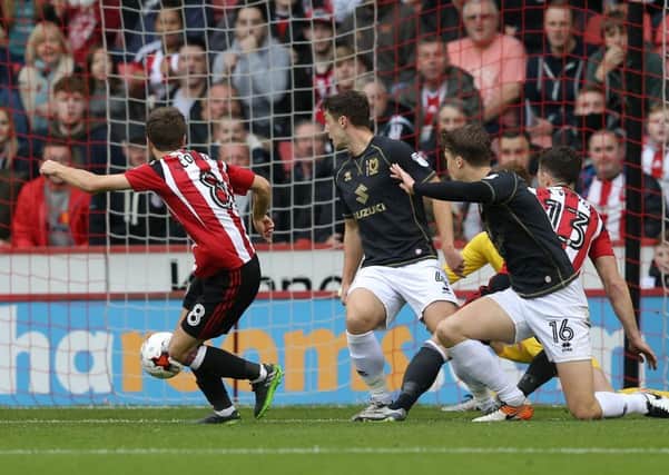 Stefan Scougall gives Sheffield United the lead against MK Dons at Bramall Lane on Saturday. The visitors equalised but Scougall set up Billy Sharp, inset, to score a winner for Chris Wilders side as they stretched their unbeaten run to 11 matches, (Picture: Simon Bellis/Sportimage)