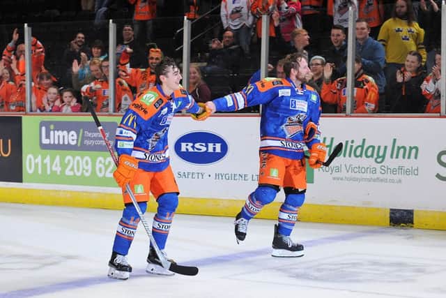 Liam Kirk takes the applause with Colton Fretter, right, after opening his Sheffield Steelers' goalscoring account against Coventry Blaze on Saturday night. Picture: Dean Woolley.