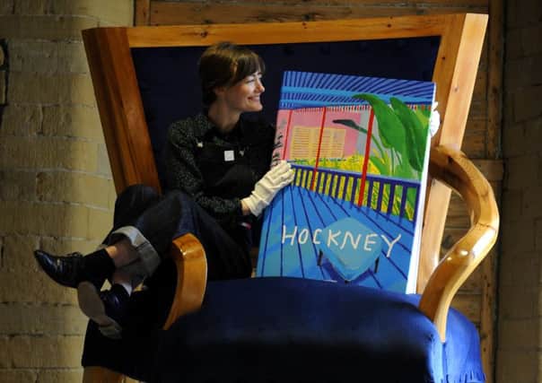 Kate Holliday, assistant manager looks at the new Bigger Book by David Hockney, at the David Hockney Gallery, Salts Mill, Saltaire. PIC: Simon Hulme