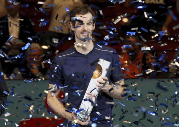 Andy Murray of Great Britain poses with the trophy amidst a shower of conafter winning the Erste Bank Open tennis tournament in Vienna, Austria on Sunday (AP/Ronald Zak