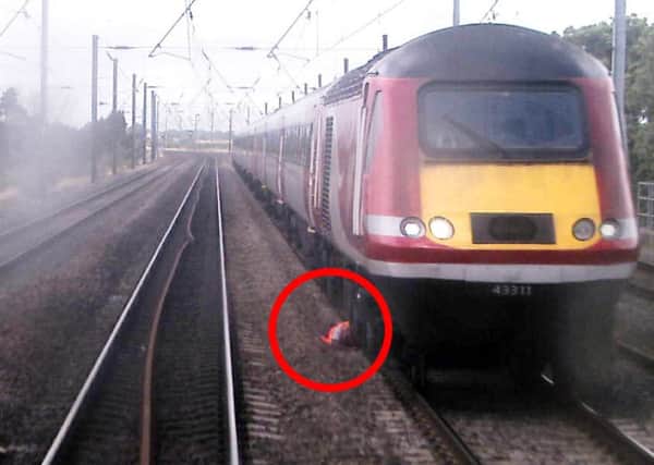 CCTV still issued by the Rail Accident Investigation Branch of a train driver who was forced to dive to the ground to avoid being hit by another train travelling at 105mph, according to an official report.