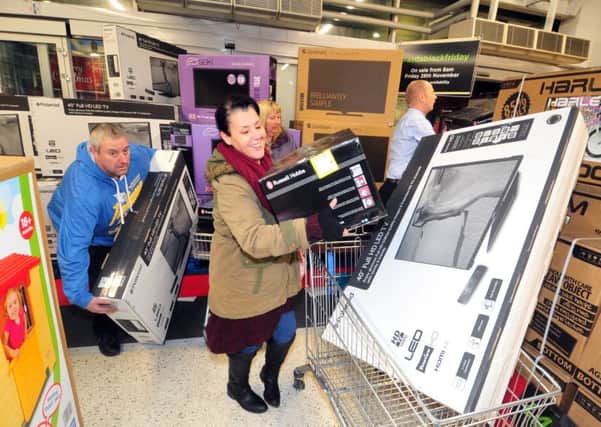 Shoppers grab bargain christmas presents on offer at ASDA Pudsey on Black Friday.