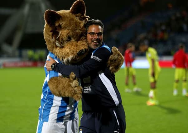 Huddersfield Town manager David Wagner celebrates a year in charge on Saturday. Here he is with club mascot Terry Terrier. (Picture: PA)