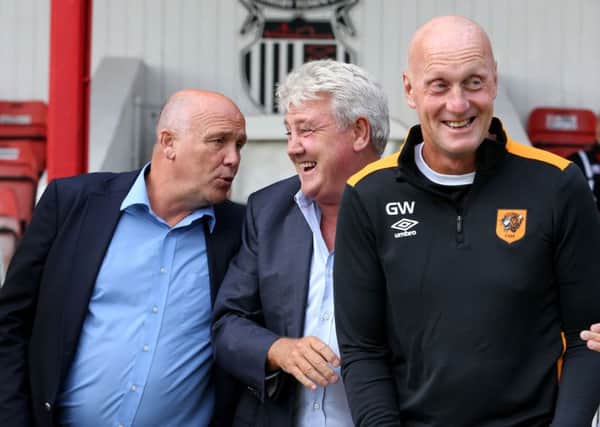 Gary Walsh, right, shares a joke with former Hull City manager Steve Bruce (centre) and current boss Mike Phelan (Photo: PA)