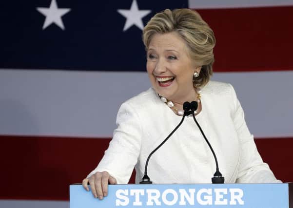 Democratic presidential candidate Hillary Clinton laughs during a campaign speech.