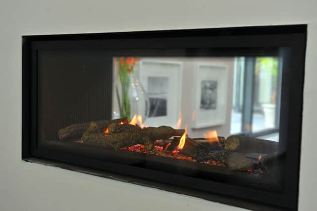 This contemporary gas fire serves both the sitting room and the dining area