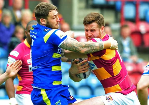 England hooker Daryl Clark, pictured engaging with Huddersfield Giants Anthony Mullally in Super League action (Picture: Tony Johnson).