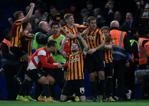 Happy memories: Bradford players celebrate in near disbelief after their memorable victory at Chelsea two years ago. (Picture: PA)