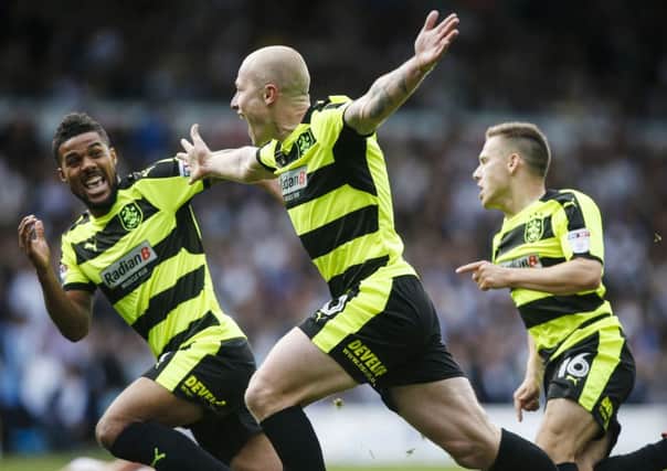Huddersfield Town's Aaron Mooy (centre) celebrates scoring his sides first goal during the Sky Bet Championship match at against Leeds. Picture:  Danny Lawson/PA