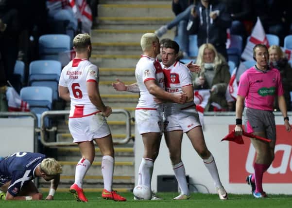 England's Mark Percival (right) celebrates scoring his sides third try of the game during the Four Nations match at the Ricoh Arena, Coventry. (Pic PA)