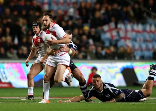 England's Luke Gale gets away from Scotland's Tyler Cassel (right) at the Ricoh Arena, Coventry. Picture: Simon Cooper/PA