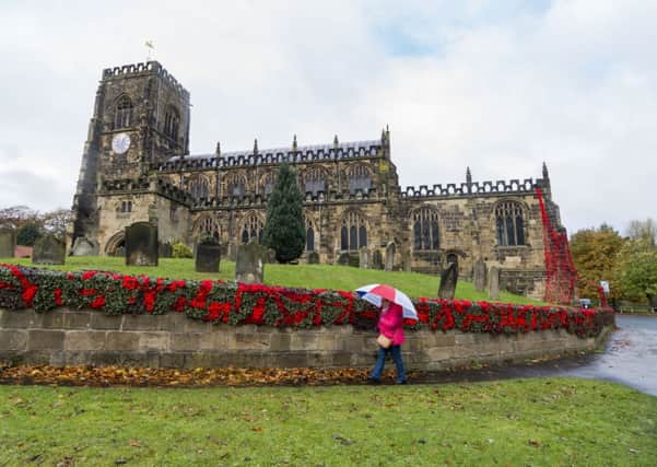 Yarnbombers have been stringing thousands of knitted poppies around Thirsk in the run up to Remembrance Day. This is  St Mary's Church. Picture by James Hardisty