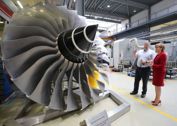 Scotland's First Minister Nicola Sturgeon looks at a Rolls-Royce Trent Aero-Engine  fan as she tours a manufacturing hub during a visit to the University of Sheffield in Rotherham.