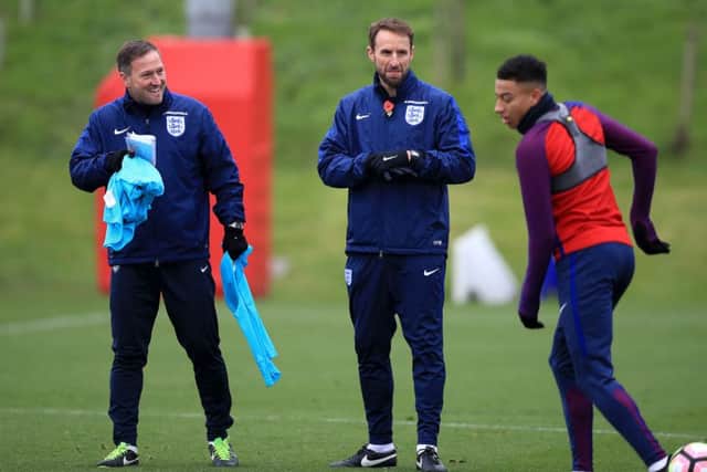 Southgate (centre) and assistant Steve Holland (left) watch Jesse Lingard (right) during a training session at St George's Park, Burton. (Photo: PA)