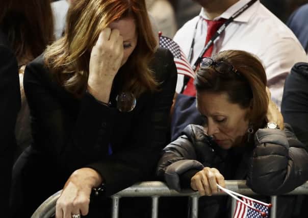Supporters react to election results during Democratic presidential nominee Hillary Clinton's election night rally