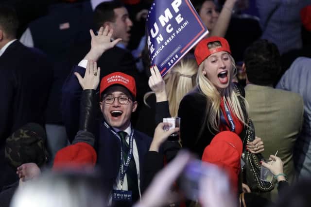 Supporters of Republican presidential candidate Donald Trump react as they watch the election results during Trump's election night rally
