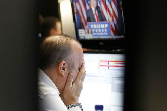 A broker reacts as newly elected US President Donald Trump shows up on a television screen at the stock market in Frankfurt, Germany