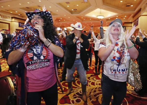 Diana Caldon, from left, Eddie Hamilton and Stephanie Smith celebrate at an election night watch party hosted by the Nevada GOP as Donald Trump wins the presidency