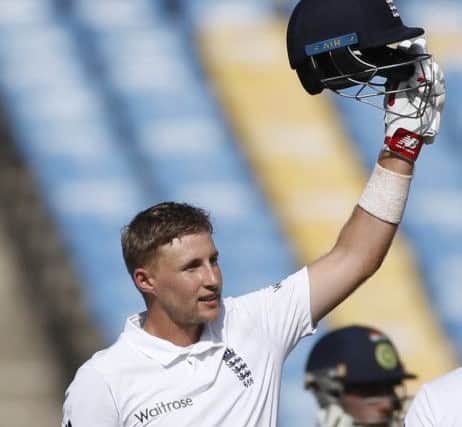 England's batsman Joe Root raises his helmet after scoring hundred during the first day of the first test cricket match between India and England in Rajkot (AP Photo/Rafiq Maqbool)