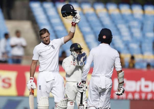 England's batsman Joe Root celebrates his century.