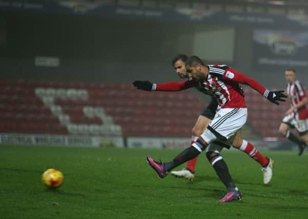 Leon Clarke of Sheffield United scores the fourth goal during the Checkatrade Trophy match at Blundell Park.