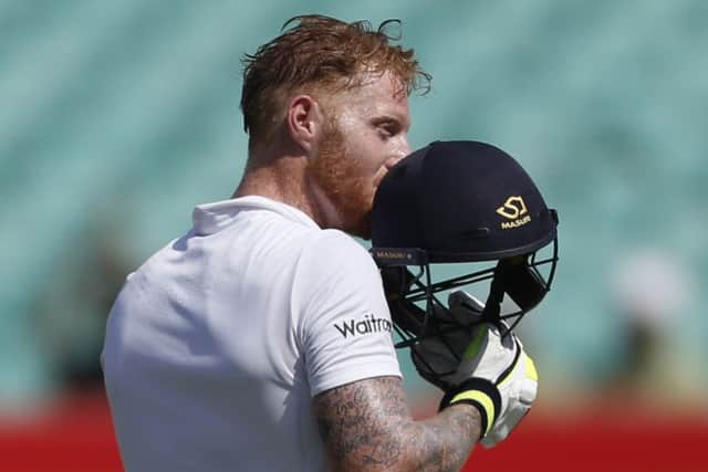England's batsman Ben Stokes kisses helmet after reaching his century