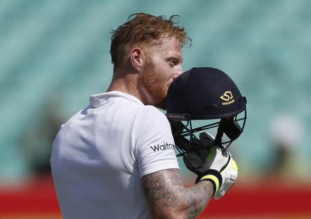 England batsman Ben Stokes celebrates after taking full advantage of sloppy India fielding and catching to reach his century in Rajkot (Picture: Rafiq Maqbool/AP).
